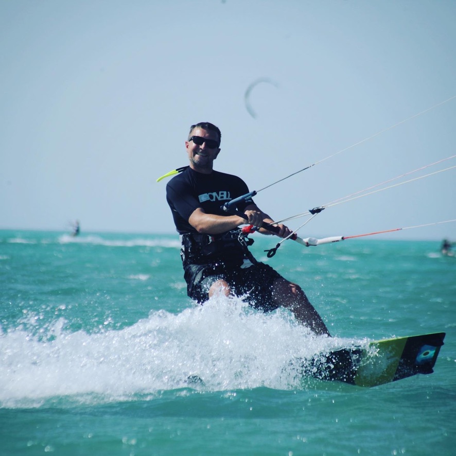 Marcel beim Kitesurfen am Strand